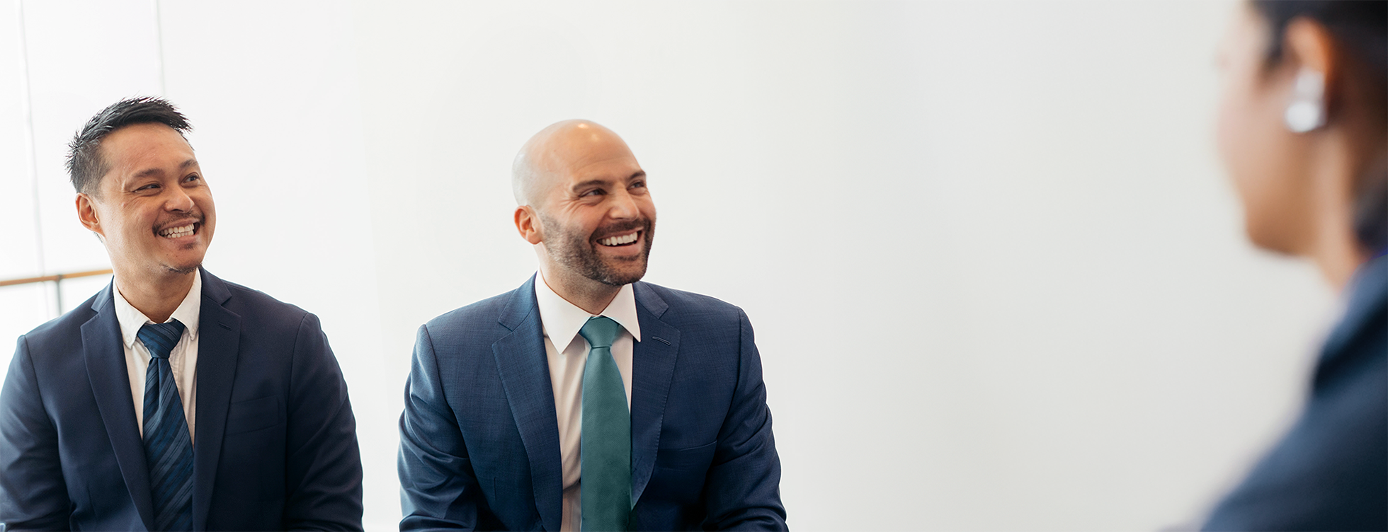 A picture of two of our people smiling as they sit together.