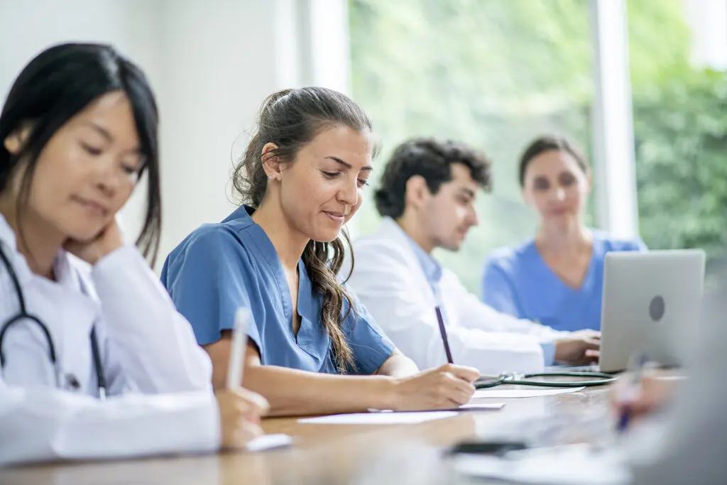 Oncology nurses take notes during a workshop funded by an association foundation.